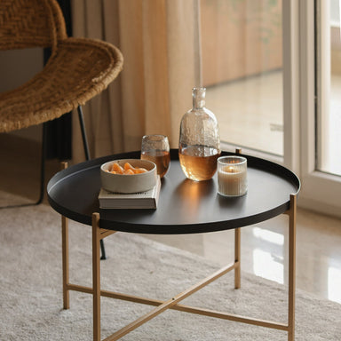 Metal side table in a living room with Black tray table .