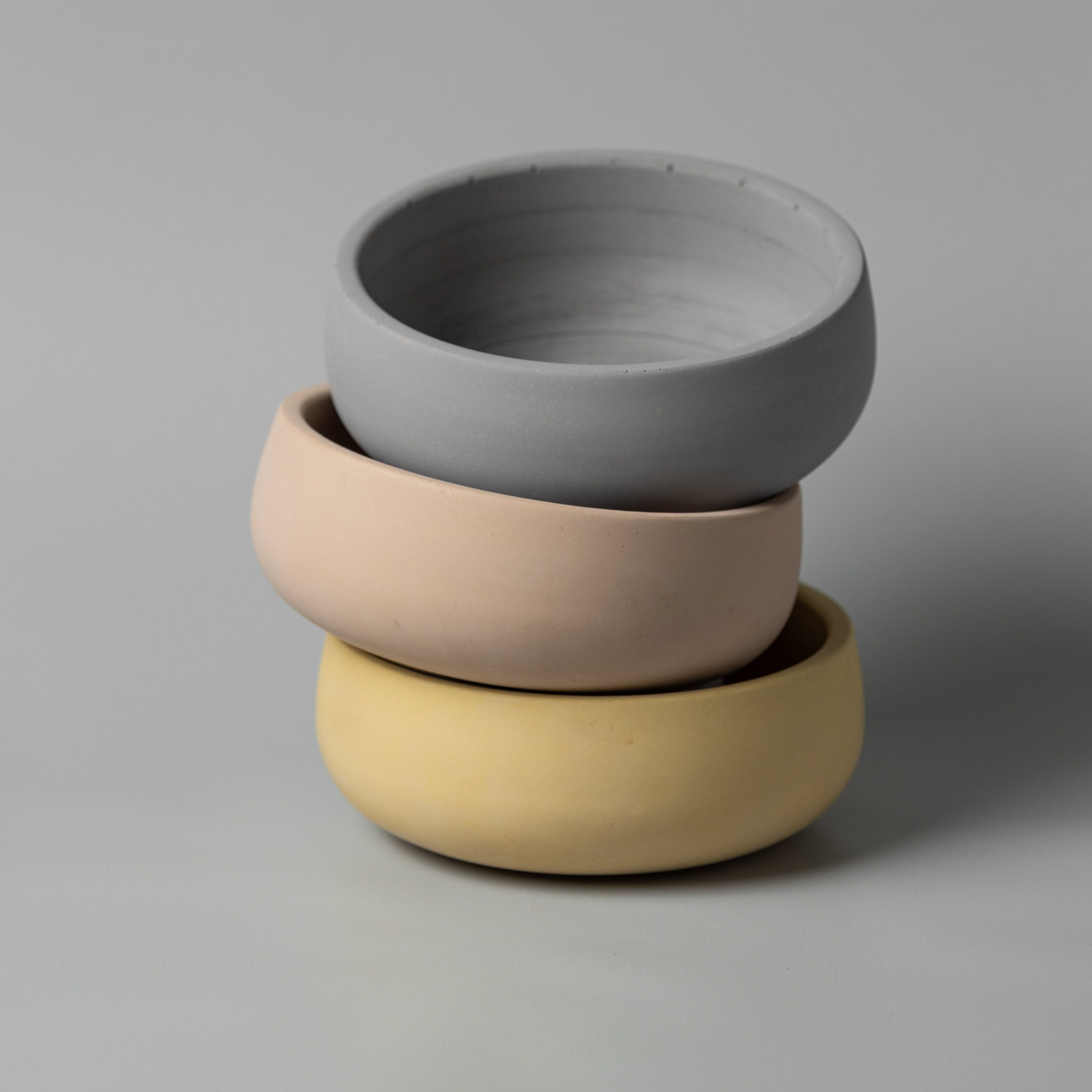 Concrete bowls in beige yellow beige stacked